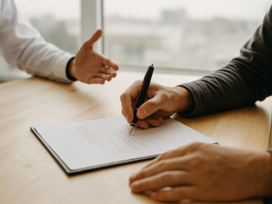 Young adult signing legal documents including a will and power of attorney in Ontario