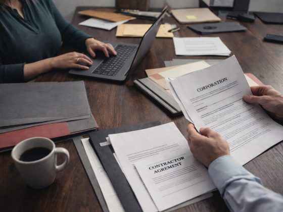 Entrepreneurs reviewing business paperwork and financial records while setting up a new company in Ontario